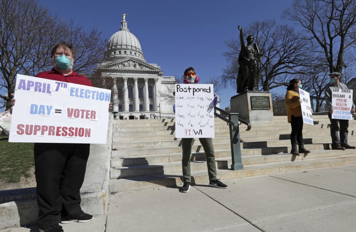 Members of the group C.O.V.I.D., Citizens Outraged Voters in Danger, protest wearing masks outside the State Capitol during a special session regarding the spring election in Madison on Saturday. Amber Arnold, Lee Newspapers